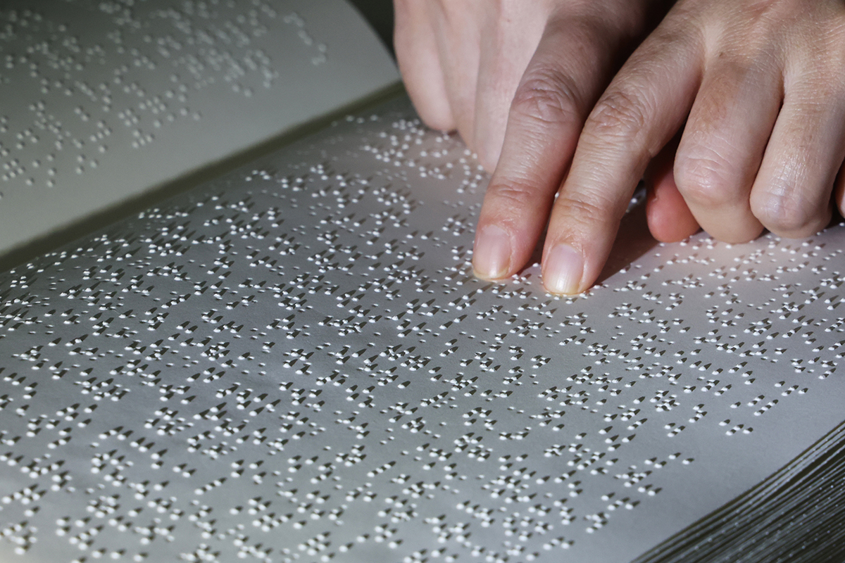 A representative from Sarangsaem Library of Suwon Welfare Center for the Disabled on the afternoon of Nov. 4, or National Braille Day, reads a braille book at the library in Yeongtong-gu District of Suwon, Gyeonggi-do Province. 